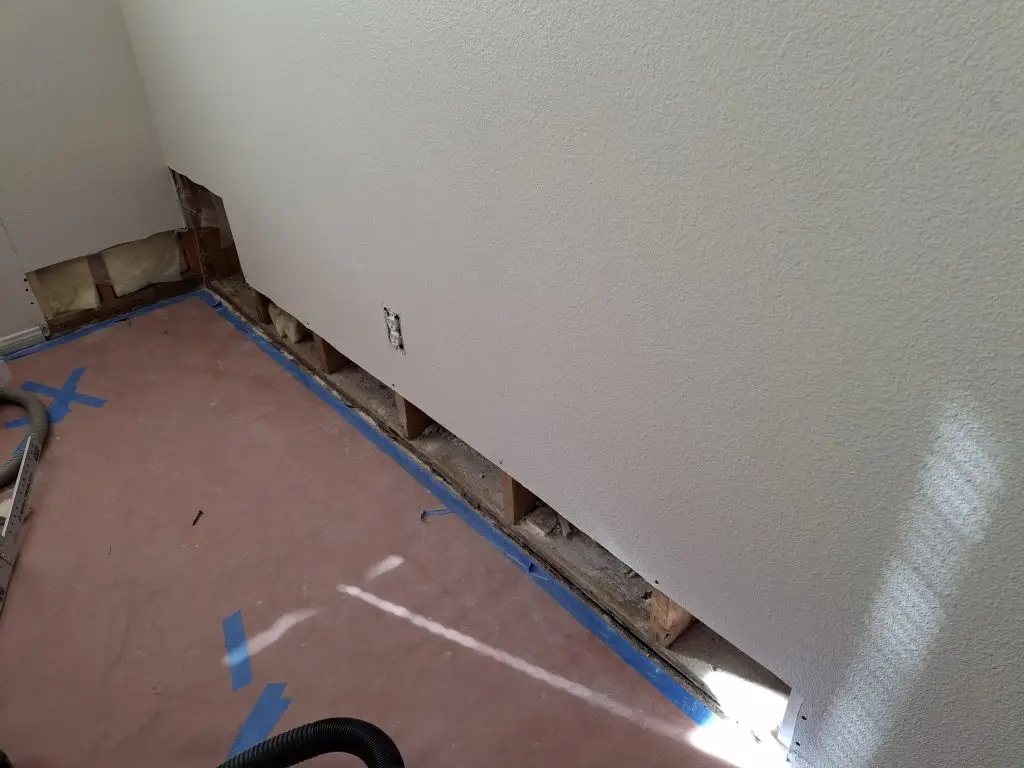 damaged walls after flood by tenant