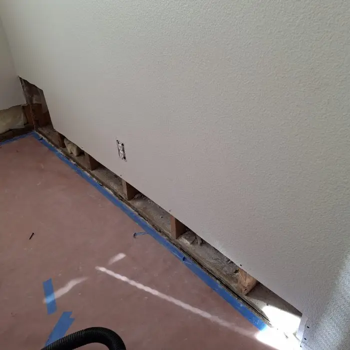 damaged walls after flood by tenant