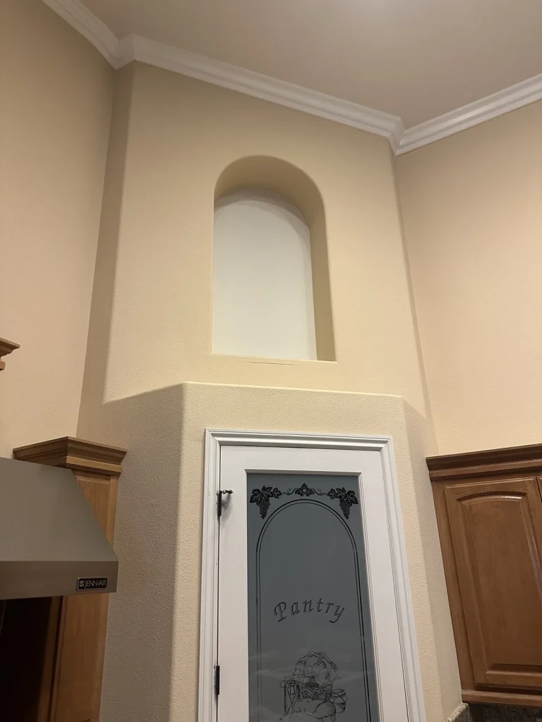 Arched niche above pantry door