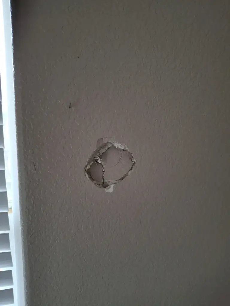 Fist-size hole in wall