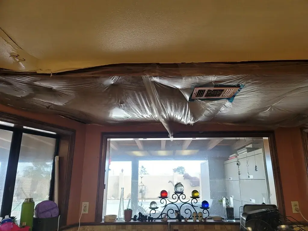 Severely water damaged kitchen ceiling before repair